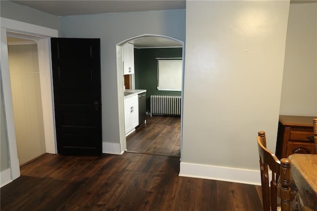 hall with dark hardwood / wood-style flooring and radiator heating unit