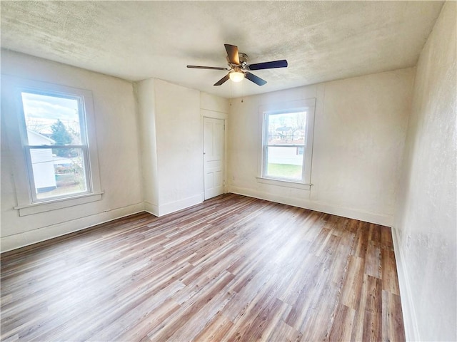 2013 S Jefferson St, Shenango Twp Law, PA 16102 - unfurnished room featuring wood finished floors, baseboards, a ceiling fan, and a textured ceiling