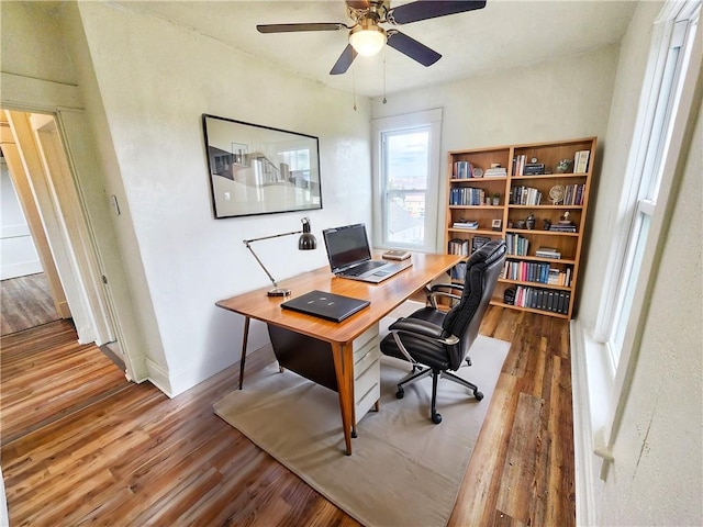 home office with ceiling fan and hardwood / wood-style floors