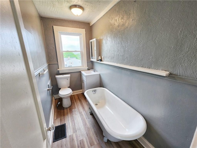 2013 S Jefferson St, Shenango Twp Law, PA 16102 - bathroom with toilet, wood finished floors, a soaking tub, and a sink