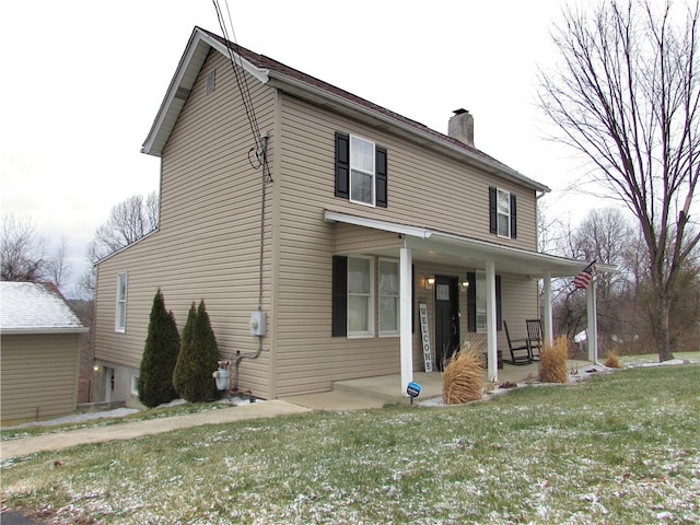 front of property featuring covered porch and a front lawn