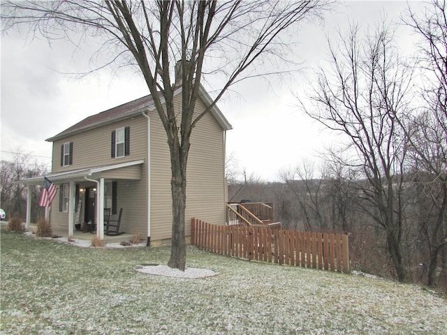 view of side of property with a porch and a yard