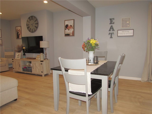 dining area with light hardwood / wood-style floors