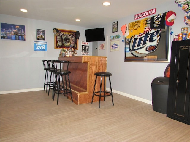 bar featuring hardwood / wood-style flooring