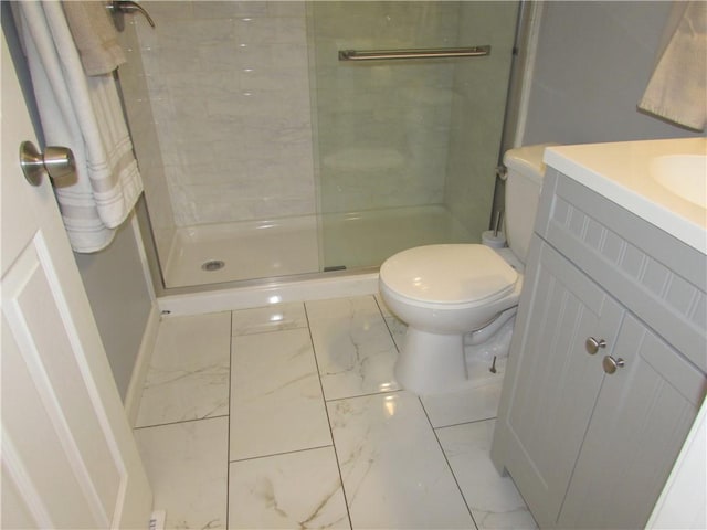 bathroom with vanity, toilet, and a tile shower