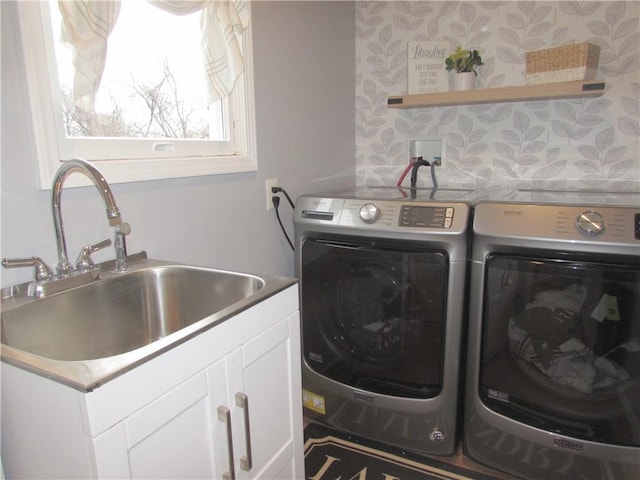 washroom featuring washer and clothes dryer, cabinets, and sink