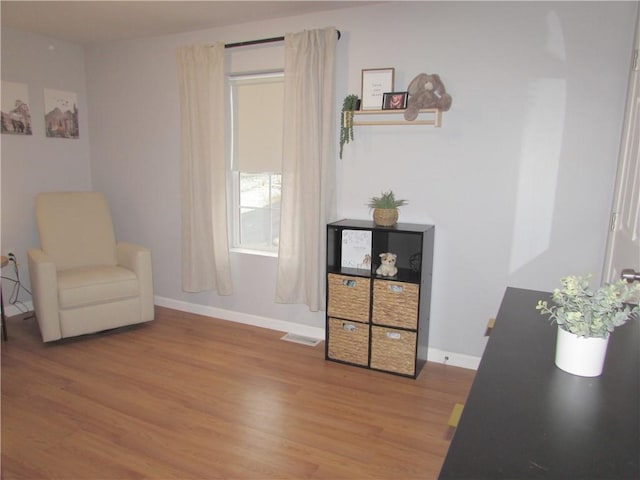 sitting room with light hardwood / wood-style flooring