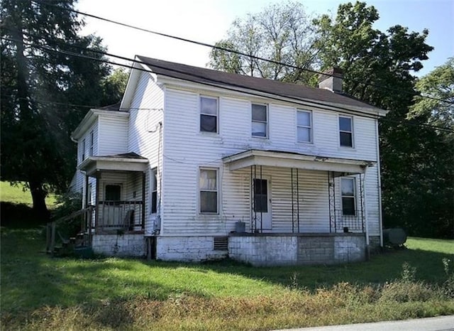 view of front of house with a porch and a front lawn