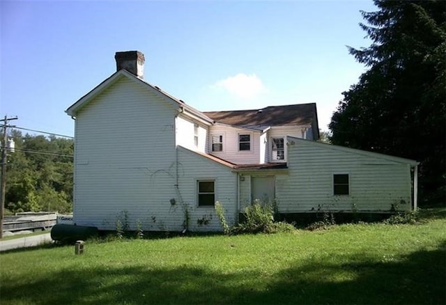 back of property featuring a yard