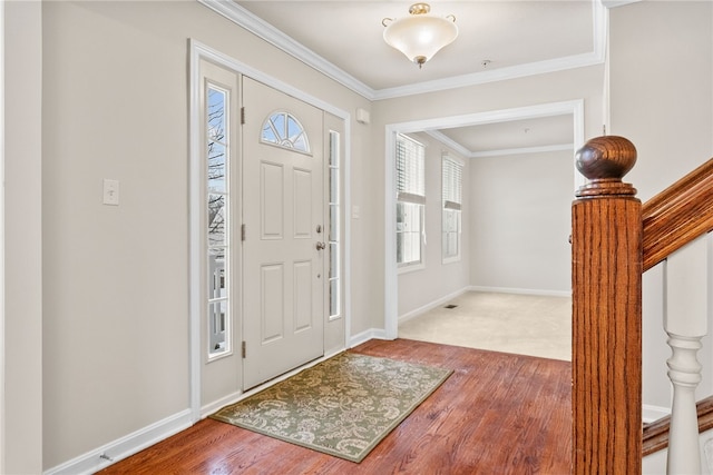 entrance foyer with crown molding and wood-type flooring