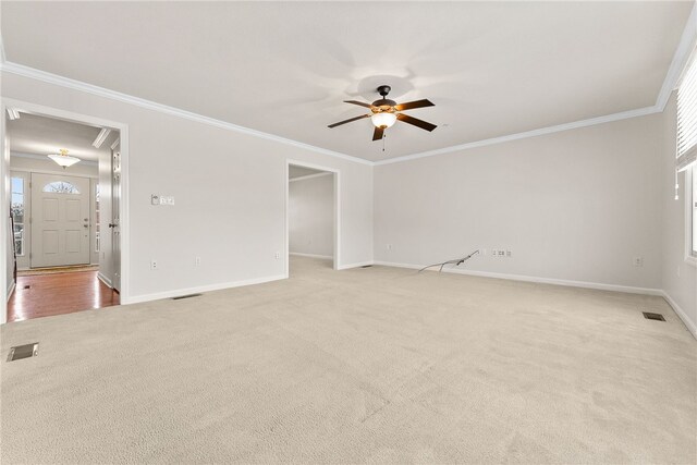 carpeted spare room featuring ceiling fan and ornamental molding