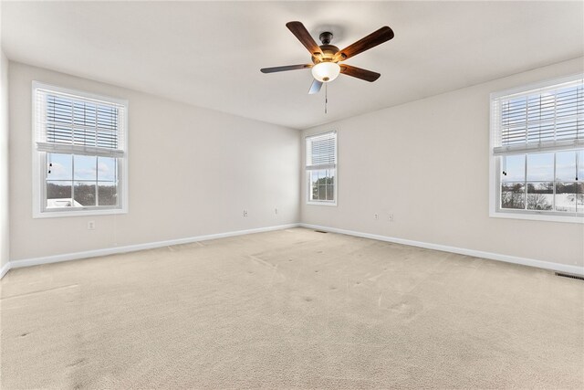 unfurnished room featuring light carpet and ceiling fan