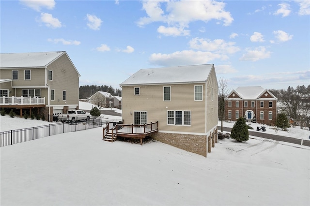 snow covered property with a wooden deck