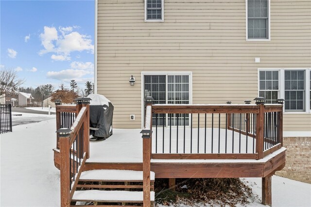 snow covered deck featuring area for grilling