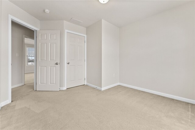 unfurnished bedroom with light carpet