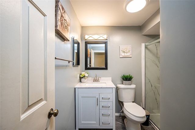 bathroom featuring vanity, toilet, and a shower with door