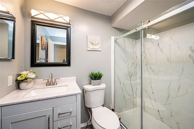 bathroom with vanity, toilet, and an enclosed shower