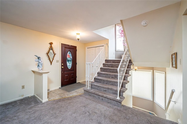 foyer entrance featuring carpet