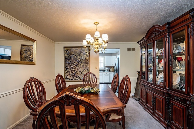 carpeted dining space with crown molding, a chandelier, and a textured ceiling