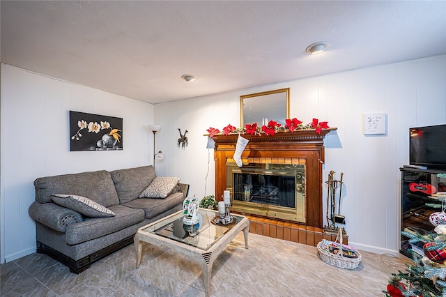 living room with a tile fireplace