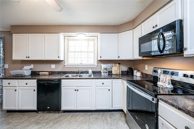 kitchen with white cabinets, sink, dark stone countertops, and black appliances