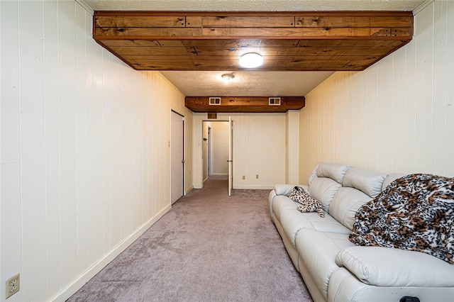 basement featuring light carpet and wood walls