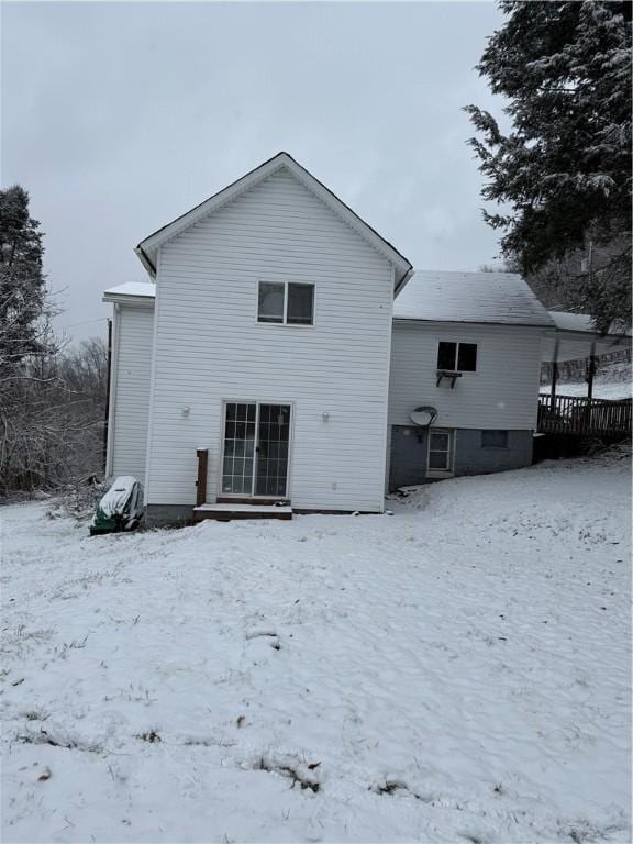 snow covered property featuring a deck