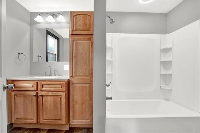 bathroom with shower / tub combination, vanity, and hardwood / wood-style flooring