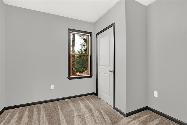 unfurnished bedroom with light colored carpet