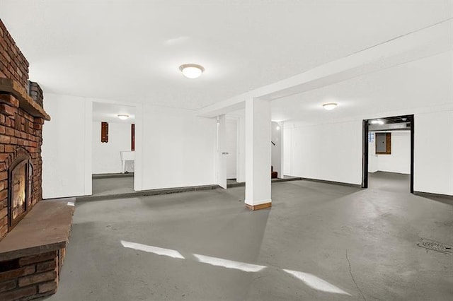 basement featuring a brick fireplace