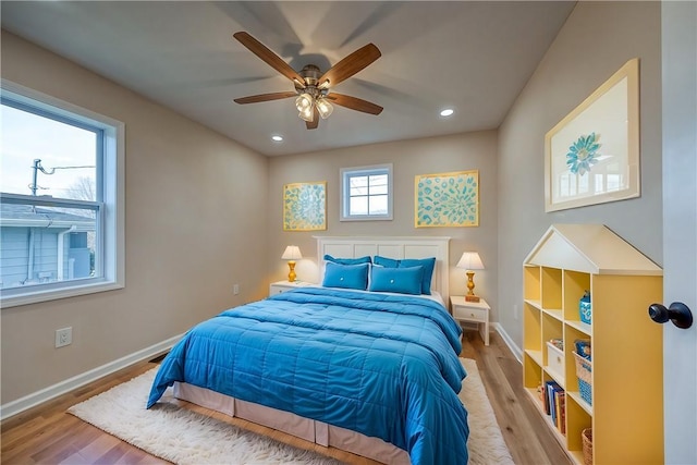 bedroom with light wood-type flooring and ceiling fan