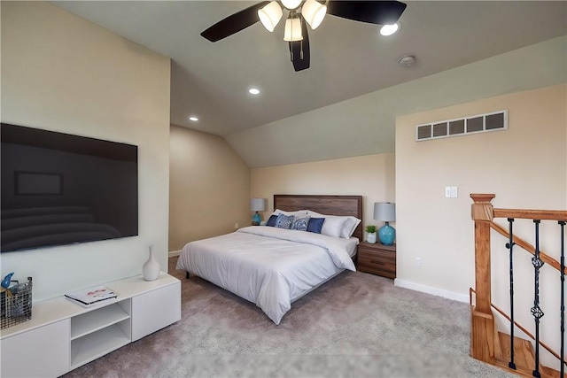 carpeted bedroom with ceiling fan and vaulted ceiling