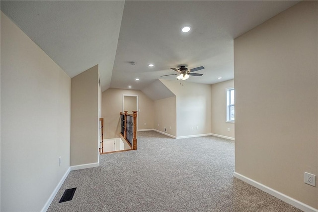 bonus room featuring light colored carpet, vaulted ceiling, and ceiling fan