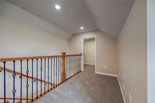 additional living space with vaulted ceiling and dark colored carpet