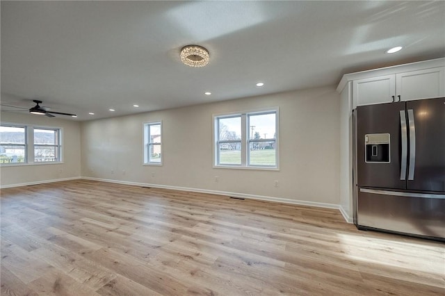 interior space featuring ceiling fan, a healthy amount of sunlight, and light hardwood / wood-style floors