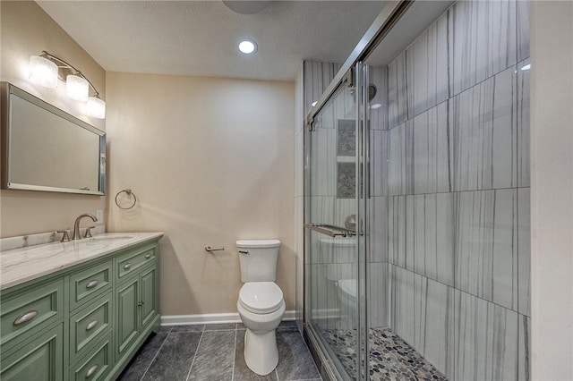 bathroom featuring vanity, toilet, and walk in shower