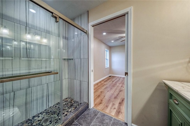 bathroom featuring ceiling fan, tile patterned flooring, vanity, and an enclosed shower