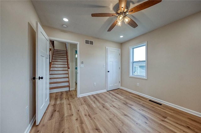 unfurnished bedroom with light wood-type flooring, a closet, and ceiling fan