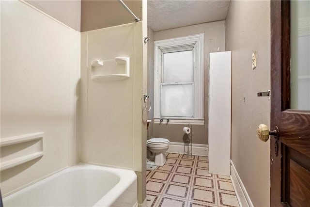 bathroom with a textured ceiling and toilet