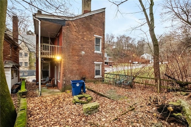 back of house featuring a balcony