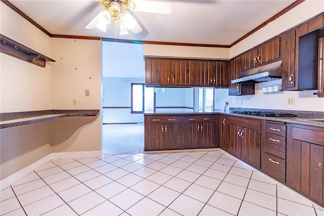 kitchen featuring ceiling fan, dark brown cabinetry, ornamental molding, and gas cooktop