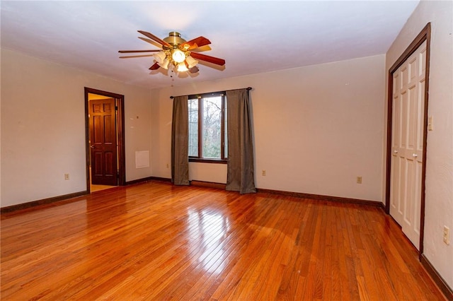 spare room featuring ceiling fan and light hardwood / wood-style floors