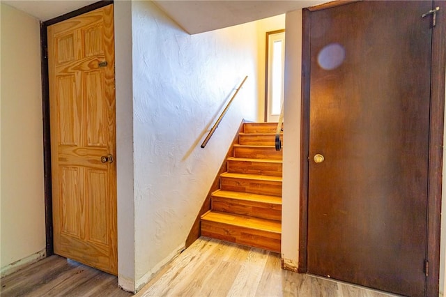 staircase with hardwood / wood-style flooring