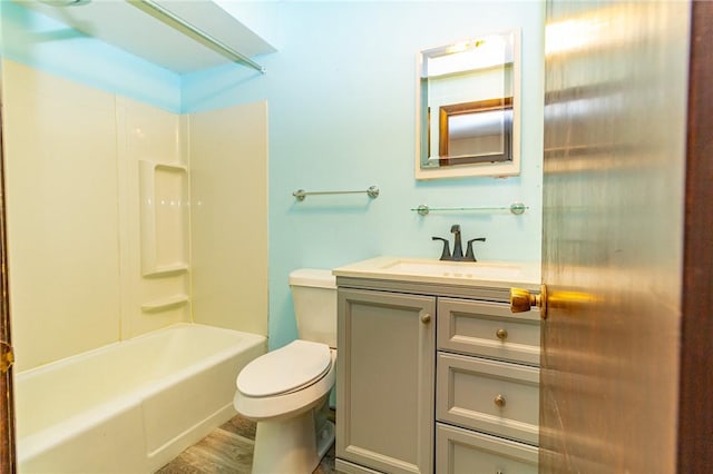 full bathroom featuring washtub / shower combination, wood-type flooring, vanity, and toilet