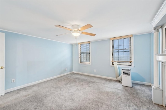 carpeted empty room with ceiling fan and ornamental molding