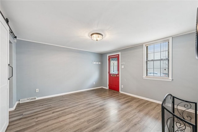 foyer with hardwood / wood-style flooring and a barn door