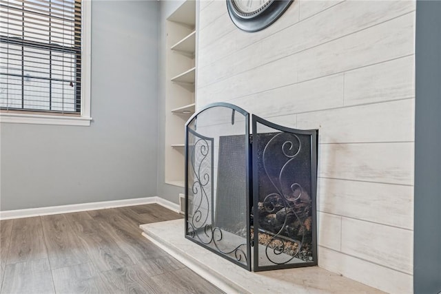 room details with hardwood / wood-style floors and built in shelves