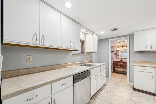 kitchen with white cabinetry, stainless steel dishwasher, and sink