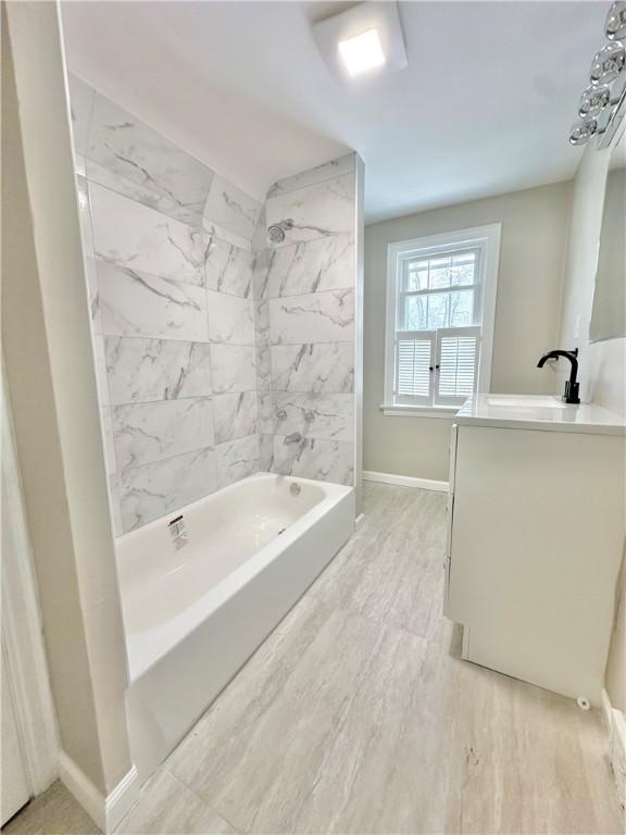 bathroom with bathing tub / shower combination, hardwood / wood-style floors, and vanity