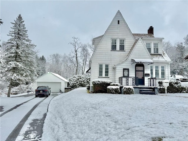 view of front of home featuring a garage and an outbuilding